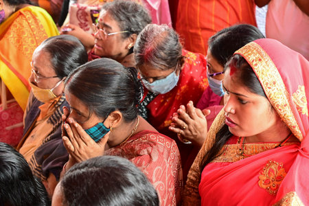 Howrah, West Bengal, India - 14th October 2021 : Hindu devotees offering pushpanjali to Goddess Durga, ritual to worship the Goddess with flowers.のeditorial素材