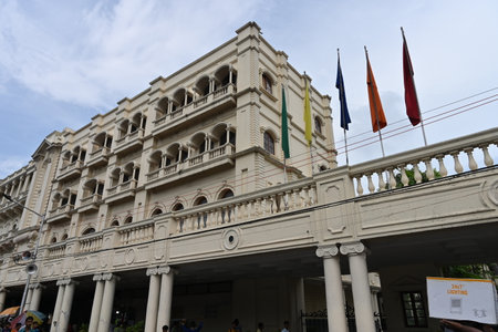 Kolkata, West Bengal, India - 21st July 2022 : Iconic Grand Hotel at Esplanade, Dharmatala area with waving flags and blue sky background. Colonial architecture.のeditorial素材