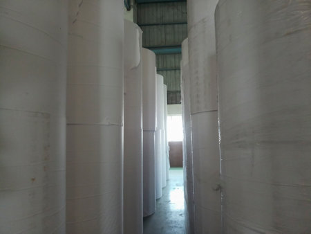 Kolkata, West Bengal, India - 5th May 2021 : White Paper Reels are stacked up after manufacturing in a paper manufacturing plant. Indian paper industry is growing.のeditorial素材