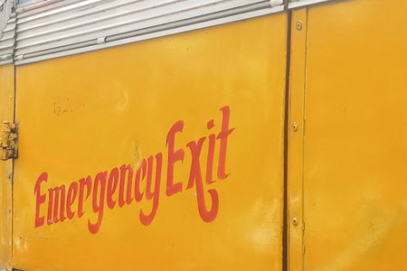 Emergency exit written in red on a bus, to indicate the emergency exit door. Kolkata, West Bengal,...