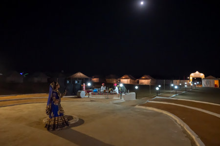 Thar desert, Rajasthan, India - October 15th 2019 : Rajasthani female dancer dancing, dressed with cultural dress of Rajasthan, at night. Musicians are playing music instruments in moonlit night.のeditorial素材