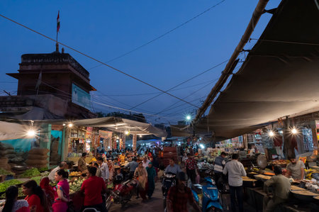 Jodhpur, Rajasthan, India - 20.10.2019 : Rajasthani buyers and sellers at famous Sardar Market and Ghanta ghar Clock tower in Jodhpur, Rajasthan, India. Blue hour image.のeditorial素材