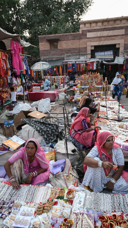 Jodhpur, Rajasthan, India - 20.10.2019 : White necklaces, gold plated earrings and ornaments are being sold to young female customers at famous Sardar Market and Ghanta ghar Clock tower in Jodhpur.のeditorial素材
