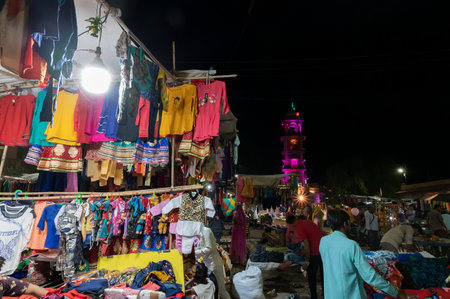 Jodhpur, Rajasthan, India - 20.10.2019 : Rajasthani womens clothes being sold at Famous Sardar Market and Ghanta ghar Clock tower in the evening.のeditorial素材