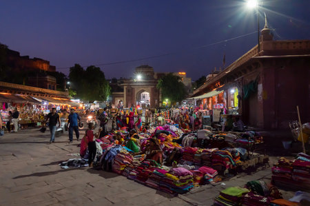 Jodhpur, Rajasthan, India - 19.10.2019 : Rajasthani womens clothes being sold at Famous Sardar Market and Ghanta ghar Clock tower in the evening.のeditorial素材