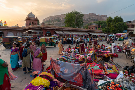 Jodhpur, Rajasthan, India - 20.10.2019 : Foreigners buying Rajasthani womens clothes being sold at Famous Sardar Market and Ghanta ghar Clock tower in the evening.のeditorial素材