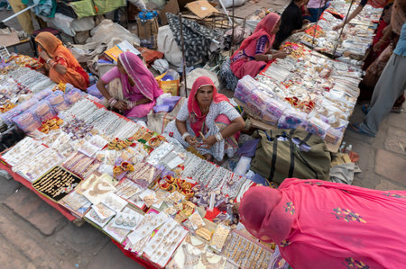 Jodhpur, Rajasthan, India - 20.10.2019 : White necklaces, gold plated earrings and ornaments are being sold to young female customers at famous Sardar Market and Ghanta ghar Clock tower in Jodhpur.のeditorial素材