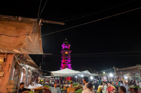 Jodhpur, Rajasthan, India - 18.10.2019 : Famous Sardar Market and Ghanta ghar Clock tower at night in Jodhpur, Rajasthan, India. Street vendors and market place in foreground.のeditorial素材