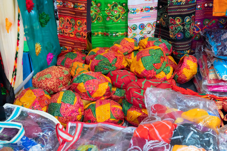 Jodhpur, Rajasthan, India - 20.10.2019 : Rajasthani womens clothes are staocked up inside store, for sale, at Famous Sardar Market and Ghanta ghar Clock tower in the evening.のeditorial素材