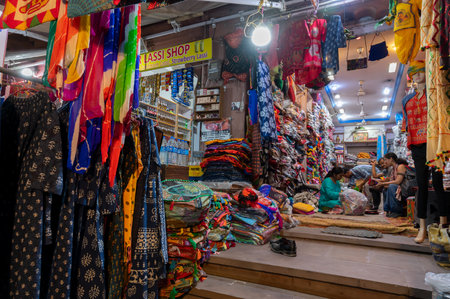 Jodhpur, Rajasthan, India - 19.10.2019 : Rajasthani womens clothes being sold in a shop at famous Sardar Market and Ghanta ghar Clock tower in the evening.のeditorial素材