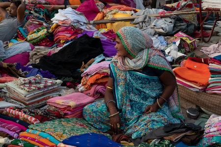 Jodhpur, Rajasthan, India - 20.10.2019 : Rajasthani womens clothes being sold at Famous Sardar Market and Ghanta ghar Clock tower in the evening.のeditorial素材