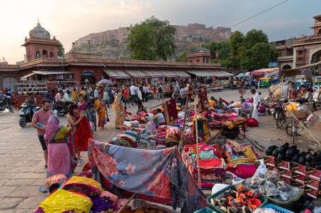 Jodhpur, Rajasthan, India - 20.10.2019 : Foreigners buying Rajasthani womens clothes being sold at Famous Sardar Market and Ghanta ghar Clock tower in the evening.のeditorial素材