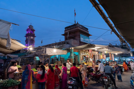 Jodhpur, Rajasthan, India - 20.10.2019 : Rajasthani buyers and sellers at famous Sardar Market and Ghanta ghar Clock tower in Jodhpur, Rajasthan, India. Blue hour image.のeditorial素材