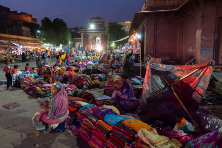 Jodhpur, Rajasthan, India - 19.10.2019 : Rajasthani womens clothes being sold at Famous Sardar Market and Ghanta ghar Clock tower in the evening.のeditorial素材