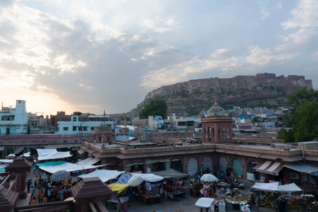 Jodhpur, Rajasthan, India - 16.10.2019 : View from top, famous Sardar Market and Ghanta ghar Clock tower with Mehrangarh fort in background.のeditorial素材