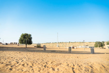 Ranautar, remote desert village inside the desert. Distant horizon, Hot summer with cloudless clear blue sky background, Thar desert, Rajasthan, India.の写真素材