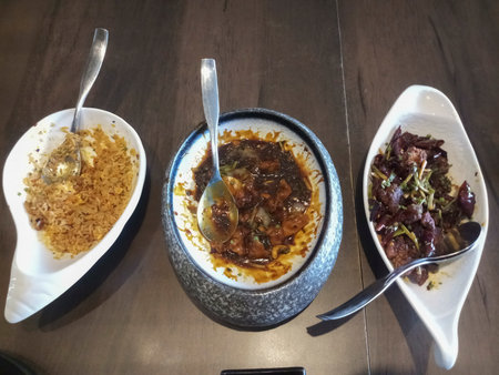 Delicous fried rice, chilli fish and chilli chicken, food being served on bamboo sticks at Park Street restaurant, Kolkata, West Bengal, India.の写真素材