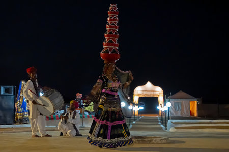 Thar desert, Rajasthan, India - October 15th 2019 : Female dancer dancing Bhavai, a folk dance, balancing six earthen pots on her head, dressed with cultural dress of Rajasthan.のeditorial素材