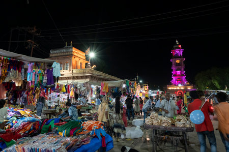 Jodhpur, Rajasthan, India - 20.10.2019 : Rajasthani womens clothes being sold at Famous Sardar Market and Ghanta ghar Clock tower in the evening.のeditorial素材