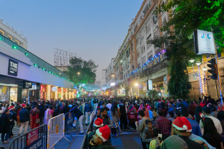 Kolkata, West Bengal, India - 26.12.2018 : Christmas celebration by enthusiastic young public at illuminated and decorated park street with lights and year end festive mood. Blue sky background.のeditorial素材