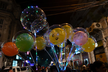 Kolkata, West Bengal, India - 26.12.2018 : Decorated balloons, lights and Christmas celebration at illuminated Park street with joy and year end festive mood. Dark sky background.のeditorial素材
