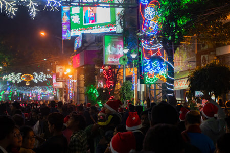 Kolkata, West Bengal, India - 26.12.2018 : Christmas celebration by enthusiastic young public at illuminated and decorated park street with lights and year end festive mood. Evening sky background.のeditorial素材