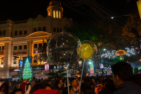 Kolkata, West Bengal, India - 26.12.2018 : Decorated balloon, lights and Christmas celebration at illuminated Park street with joy and year end festive mood. Dark sky background.のeditorial素材