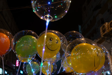 Kolkata, West Bengal, India - 26.12.2018 : Decorated balloons, lights and Christmas celebration at illuminated Park street with joy and year end festive mood. Dark sky background.のeditorial素材