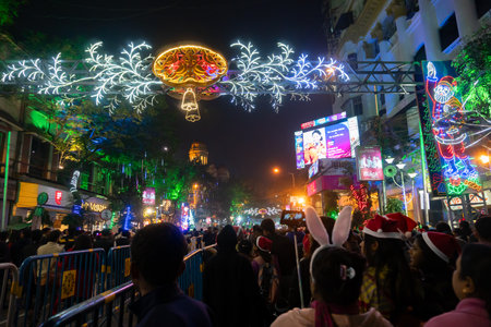 Kolkata, West Bengal, India - 26.12.2018 : Christmas celebration by enthusiastic young public at illuminated and decorated park street with lights and year end festive mood. Evening sky background.のeditorial素材