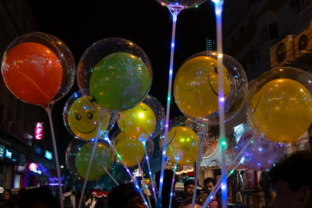Kolkata, West Bengal, India - 26.12.2018 : Colorful decorated balloons, lights and Christmas celebration at illuminated Park street with joy and year end festive mood. Dark sky background.のeditorial素材