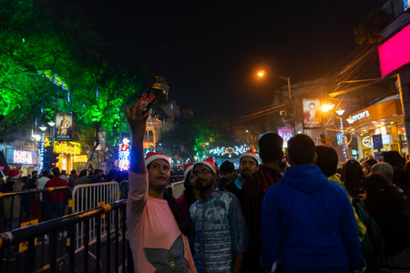 Kolkata, West Bengal, India - 26.12.2018 : Young people enjoying themselves at illuminated and decorated park street with lights with year end festive mood.のeditorial素材
