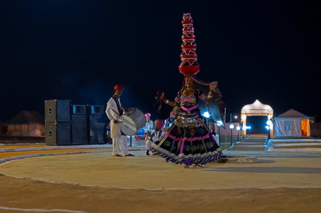 Thar desert, Rajasthan, India - October 15th 2019 : Female dancer dancing Bhavai, a folk dance, balancing six earthen pots on her head, dressed with cultural dress of Rajasthan.のeditorial素材