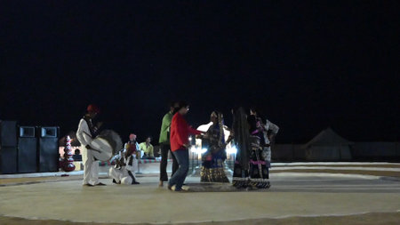 Thar desert, Rajasthan, India - October 15th 2019 : Urban female tourist dancing with Rajasthani folk dancers dressed with cultural dresses of Rajasthan. Desert night cultural program.のeditorial素材