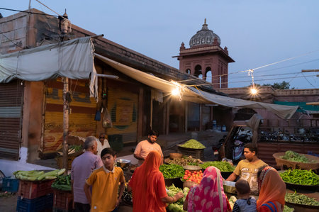 Jodhpur, Rajasthan, India - 20.10.2019 : Rajasthani buyers and sellers at famous Sardar Market and Ghanta ghar Clock tower in Jodhpur, Rajasthan, India. Blue hour image.のeditorial素材