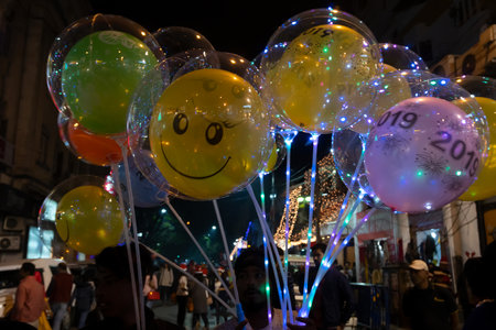 Kolkata, West Bengal, India - 26.12.2018 : Colorful decorated balloons, lights and Christmas celebration at illuminated Park street with joy and year end festive mood. Dark sky background.のeditorial素材