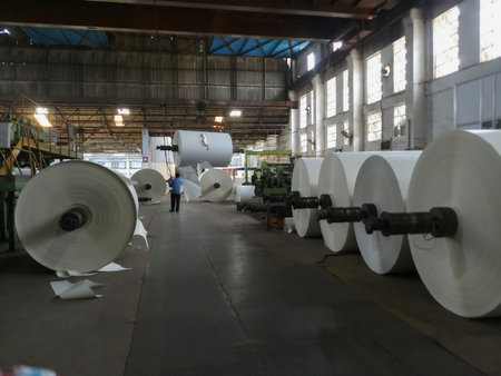 Kolkata, West Bengal, India - 16th May 2019 : White Paper Reels are being manufactured in a big paper manufacturing plant. Indian paper industry is growing.のeditorial素材