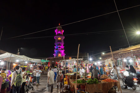 Jodhpur, Rajasthan, India - 18.10.2019 : Famous Sardar Market and Ghanta ghar Clock tower at night in Jodhpur, Rajasthan, India. Street vendors and market place in foreground.のeditorial素材
