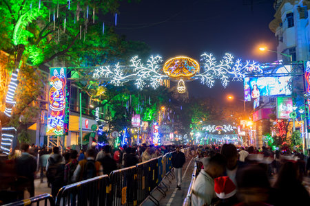 Kolkata, West Bengal, India - 26.12.2018 : Christmas celebration by enthusiastic young public at illuminated and decorated park street with lights and year end festive mood. Evening sky background.のeditorial素材