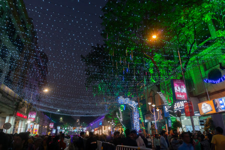 Kolkata, West Bengal, India - 26.12.2018 : Christmas celebration by enthusiastic young public at illuminated and decorated park street with lights and year end festive mood. Evening sky background.のeditorial素材
