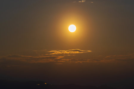 Rise of the orange moon, also known as the harvest moon or the hunter's moon, over the night sky at Sikkim, India. Moon orange due to atmosphere.の写真素材