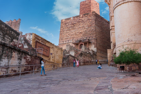 Jodhpur, Rajasthan, India - 19th October 2019 : Young Indian girl taking picture of another girl sitting on Mehrangarh fort yard. The fort is UNESCO world heritage site and a popular tourist spot.のeditorial素材