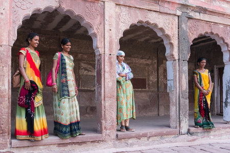 Jodhpur, Rajasthan, India - 19th October 2019 : Beautiful middle aged Rajasthani women posing wearing traditional colourful rajasthani dresses at Mehrangarh fort. Rajasthan is full of colours.のeditorial素材