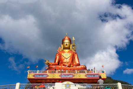 Holy statue of Guru Padmasambhava or born from a lotus, Guru Rinpoche, was a Indian tantric Buddhist Vajra master who taught Vajrayana in Tibet. Blue sky and white clouds, Samdruptse, Sikkim, India.の写真素材
