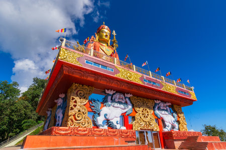 Holy statue of Guru Padmasambhava or born from a lotus, Guru Rinpoche, was a Indian tantric Buddhist Vajra master who taught Vajrayana in Tibet. Blue sky and white clouds, Samdruptse, Sikkim, India.の写真素材