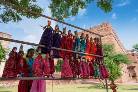 Jodhpur, Rajasthan, India - 19th October 2019 : Young Rajasthani woman selling hand made Rajaasthani colourful dolls of horse and elephant. Rajasthan is famous for its vibrant colors all across.のeditorial素材