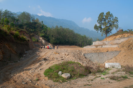 High altitude playground and stadium is being made by cutting tree and levelling Himalayan soil, Environmental damage to Himalayan mountains casuing natural disaster in mountains, Sikkim, India.の写真素材
