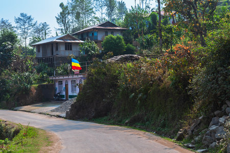 View of Sikkim village with affordable home stays for tourists, blue sky and Himalayan mountains in the background. Sikkim has a very thriving tourism industry based on tourists visiting Sikkim,India.の写真素材