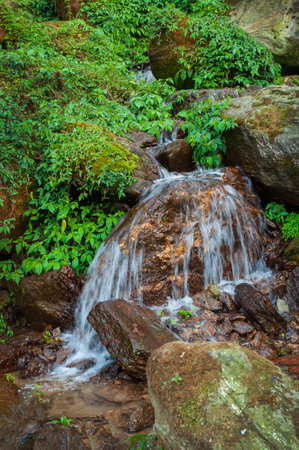 Water flowing through stones,beautiful waterfall inside Himalayan forest, Sikkim, India. Sikkim has many scenic waterfalls flowing across the state and these falls are very popular tourist attraction.の写真素材