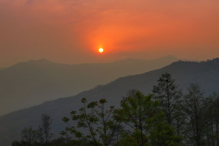 Beautiful sunrise in mountains of Himalayas, Hee Barmiok village of Sikkim, India. Great Himalayan mountain peaks in the background.の写真素材