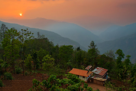 Beautiful sunrise in mountains of Himalayas, Hee Barmiok village of Sikkim, India. Wooden houses in the middle of scenic view of Sikkim.の写真素材